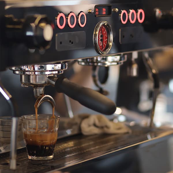 Artisanal espresso preparation Freshly pulled espresso shot in a white cup at Flocafe Espresso Room
