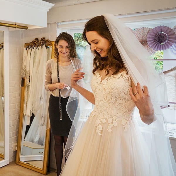 Bride on wedding day Bride in white wedding dress smiling during ceremony moment captured professionally