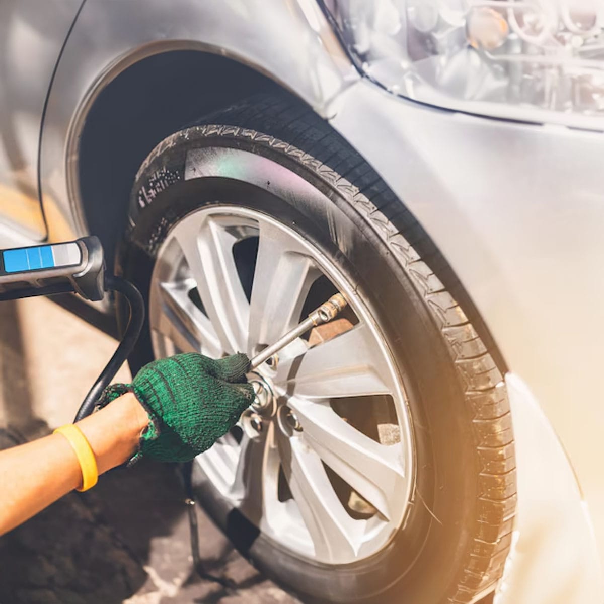 Nitrogen inflation service Local garage technician inflating car tyre with nitrogen gas equipment
