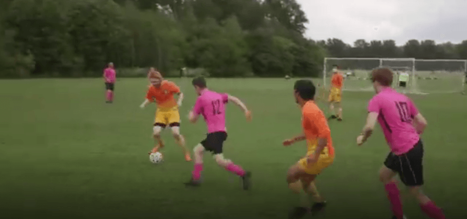 Match gameplay in progress Soho FC players in action during a competitive football match