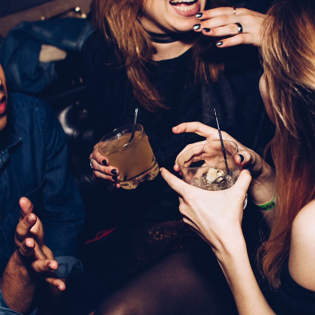Rooftop party guests enjoying food and drinks with city skyline backdrop