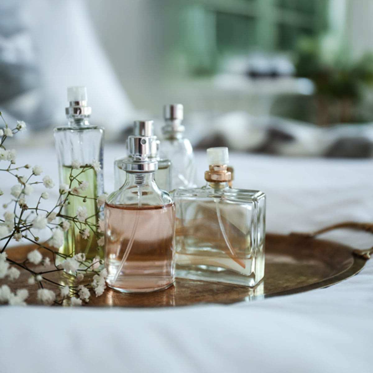 Seasonal scent selection Custom perfume bottle displayed alongside seasonal fragrance notes and styling elements