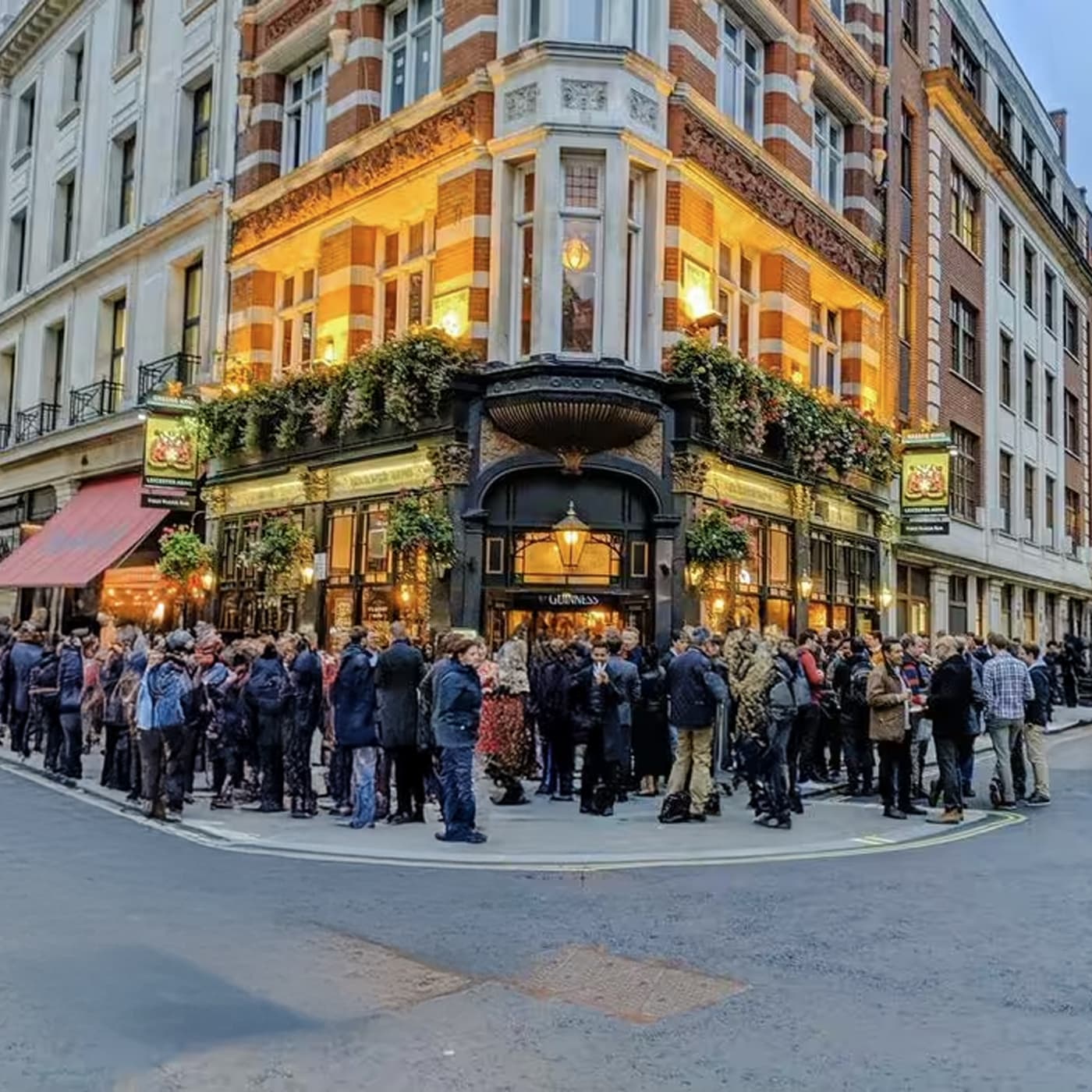 Busy Soho street scene with pedestrians walking past shops and restaurants