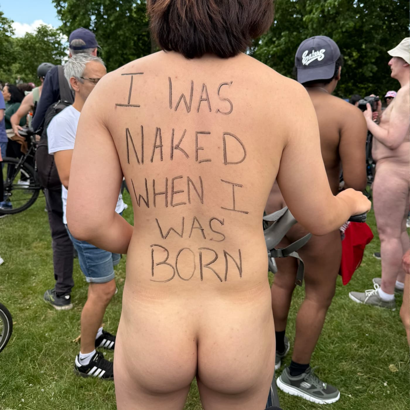 Body as protest canvas Cyclist with protest slogan written on bare skin during London naked bike ride