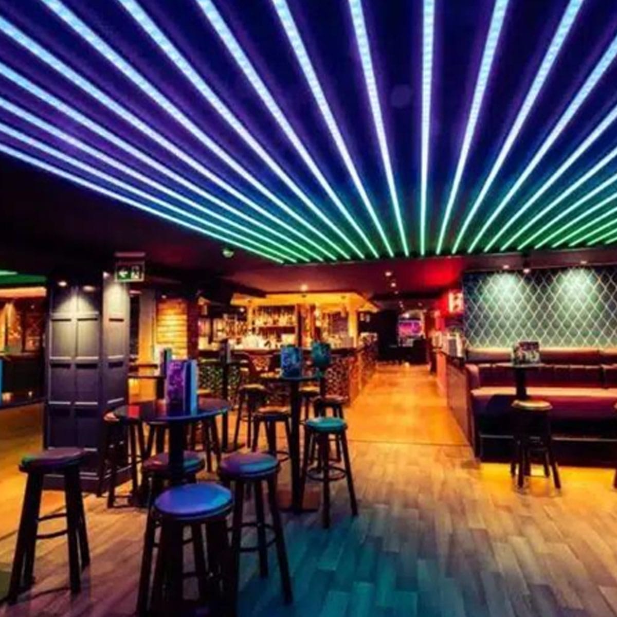 Evening venue ambiance Soho nightlife venue interior with bar seating and atmospheric lighting setup