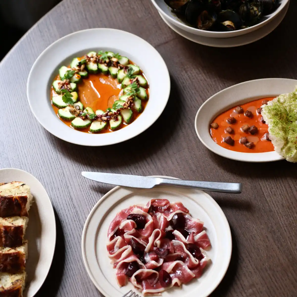 ALTA restaurant interior showing live-fire cooking setup and wooden grill counter in Soho