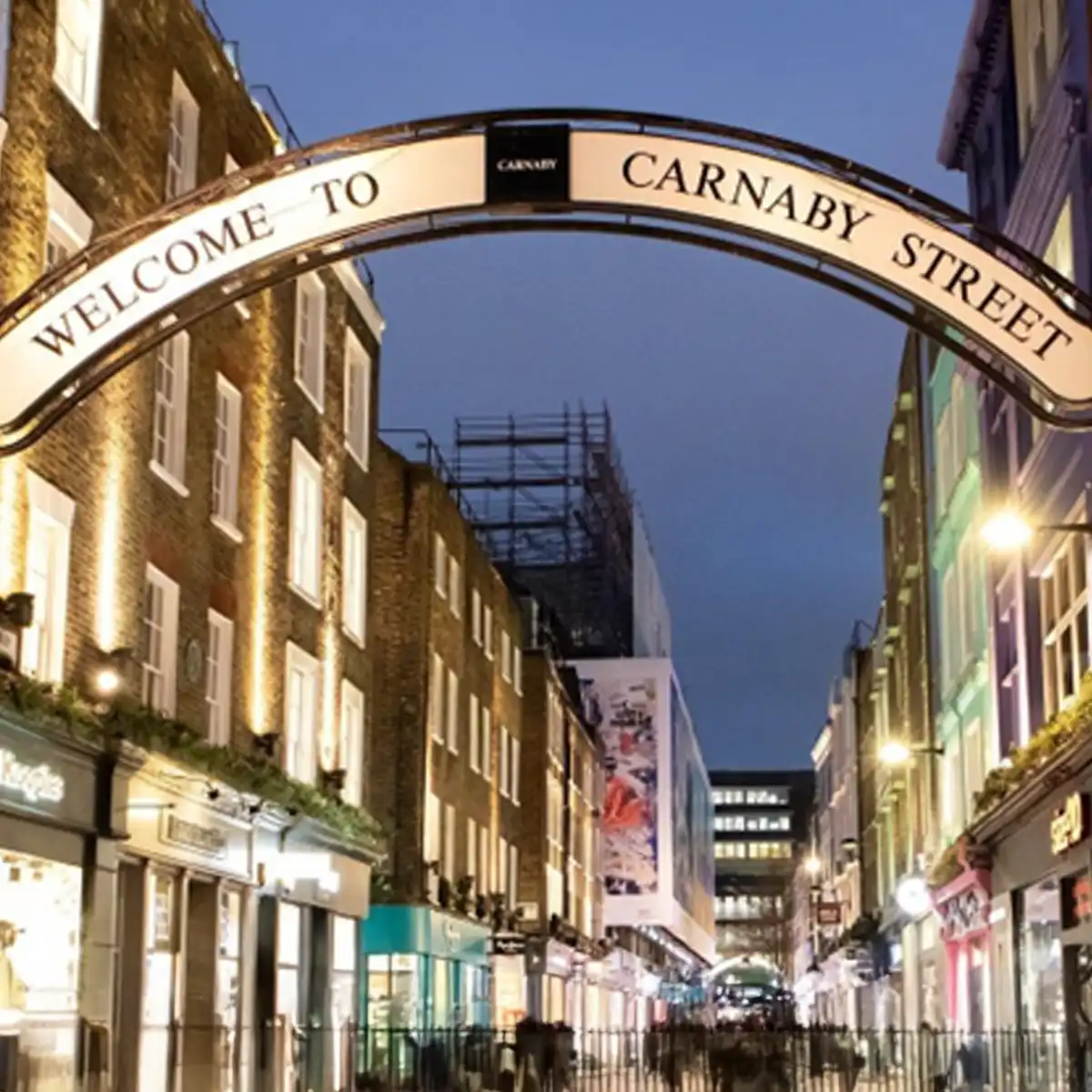 Carnaby Street evening scene Carnaby Street at night illuminated with shop fronts and pedestrians