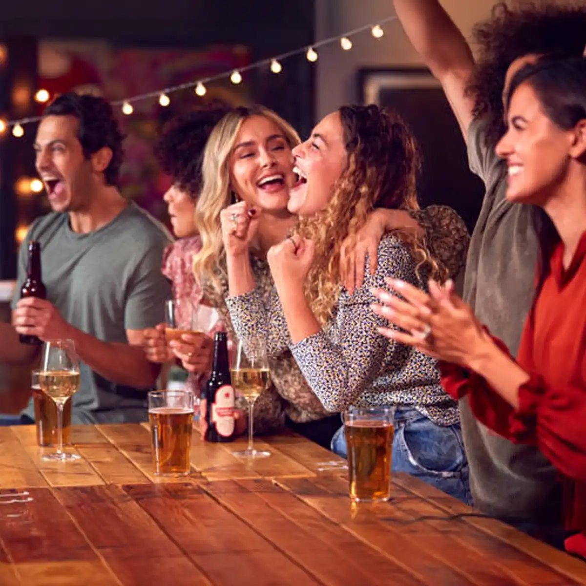 Sport meets social atmosphere Soho pub interior with football match displayed on screen and patrons socialising