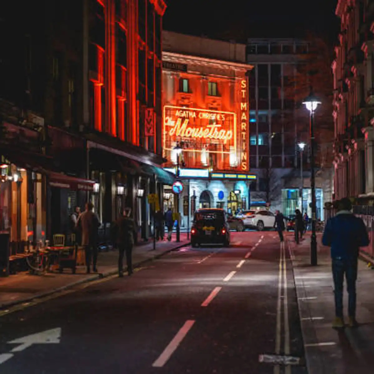 Soho street scene showing local guides and community interactions welcoming newcomers