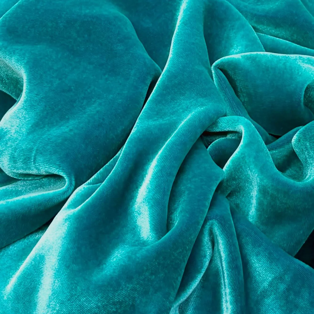 Turquoise silk velvet draped at Borovick Fabrics, the Berwick Street fabric house