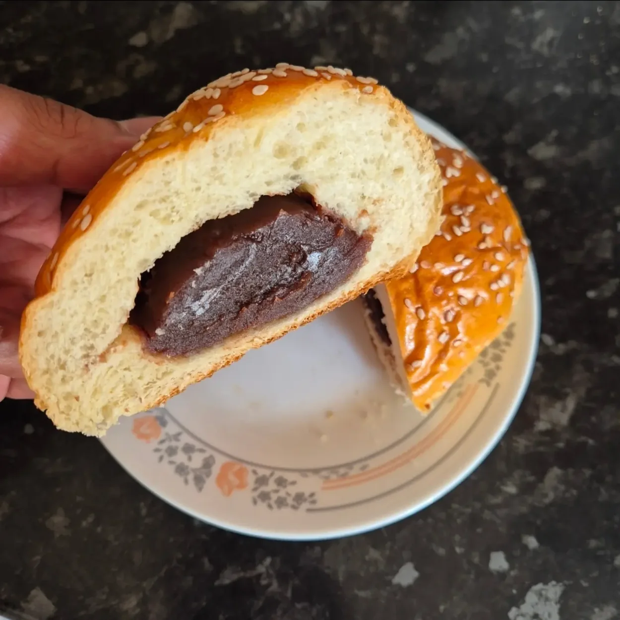 Sesame bun cut open to show sweet red bean filling at Chinatown Bakery