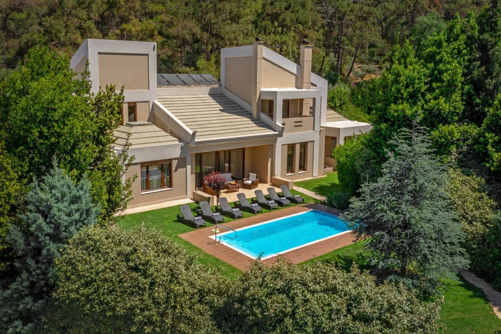 Detached villa with private pool and mature gardens, the kind of Greek residential property UK investors consider for the Golden Visa