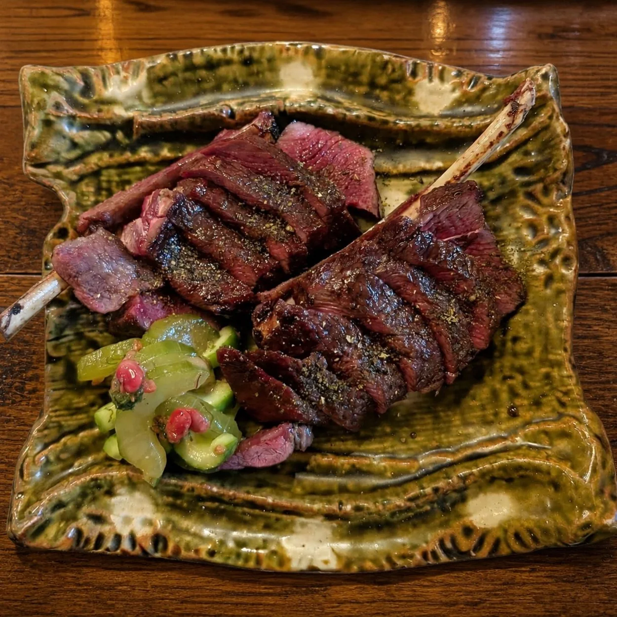 Charcoal-grilled steak sliced on a ceramic plate at HIMI Japanese restaurant in Soho