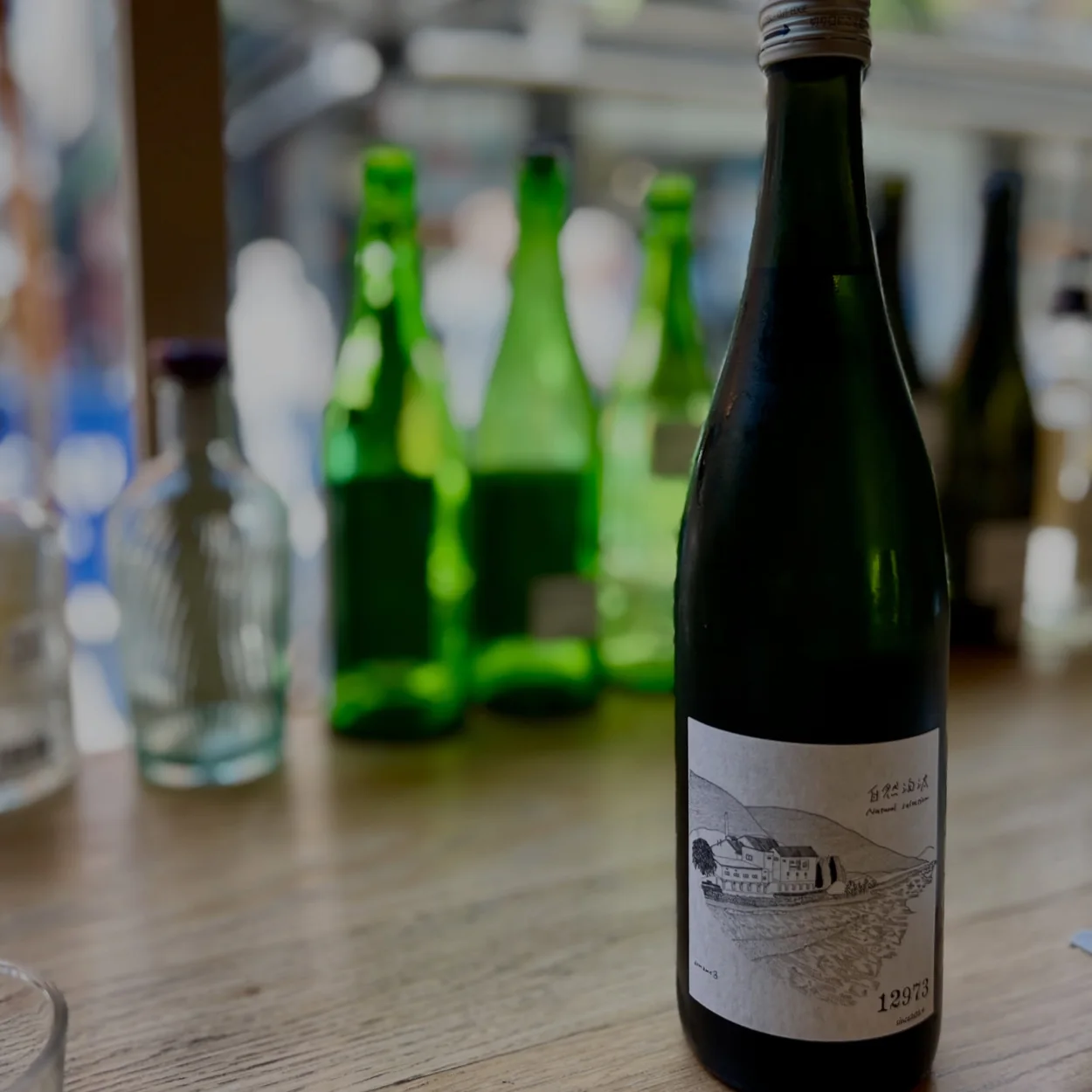 Single bottle of small-producer sake on the bar at HIMI in Soho