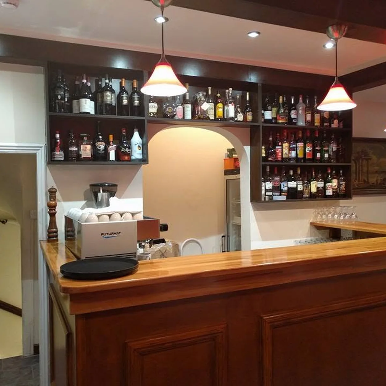 Espresso machine and spirits behind the timber bar at Il Cucciolo Soho