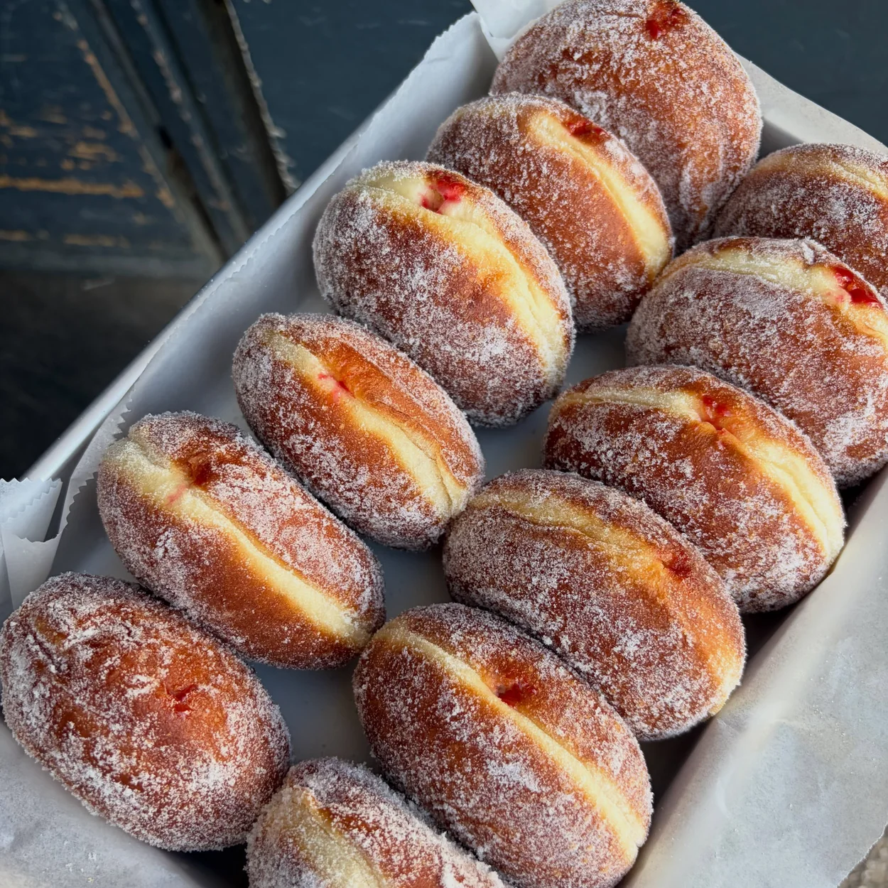 Tray of sugar-dusted jam doughnuts fresh from the Jolene bakery in Soho