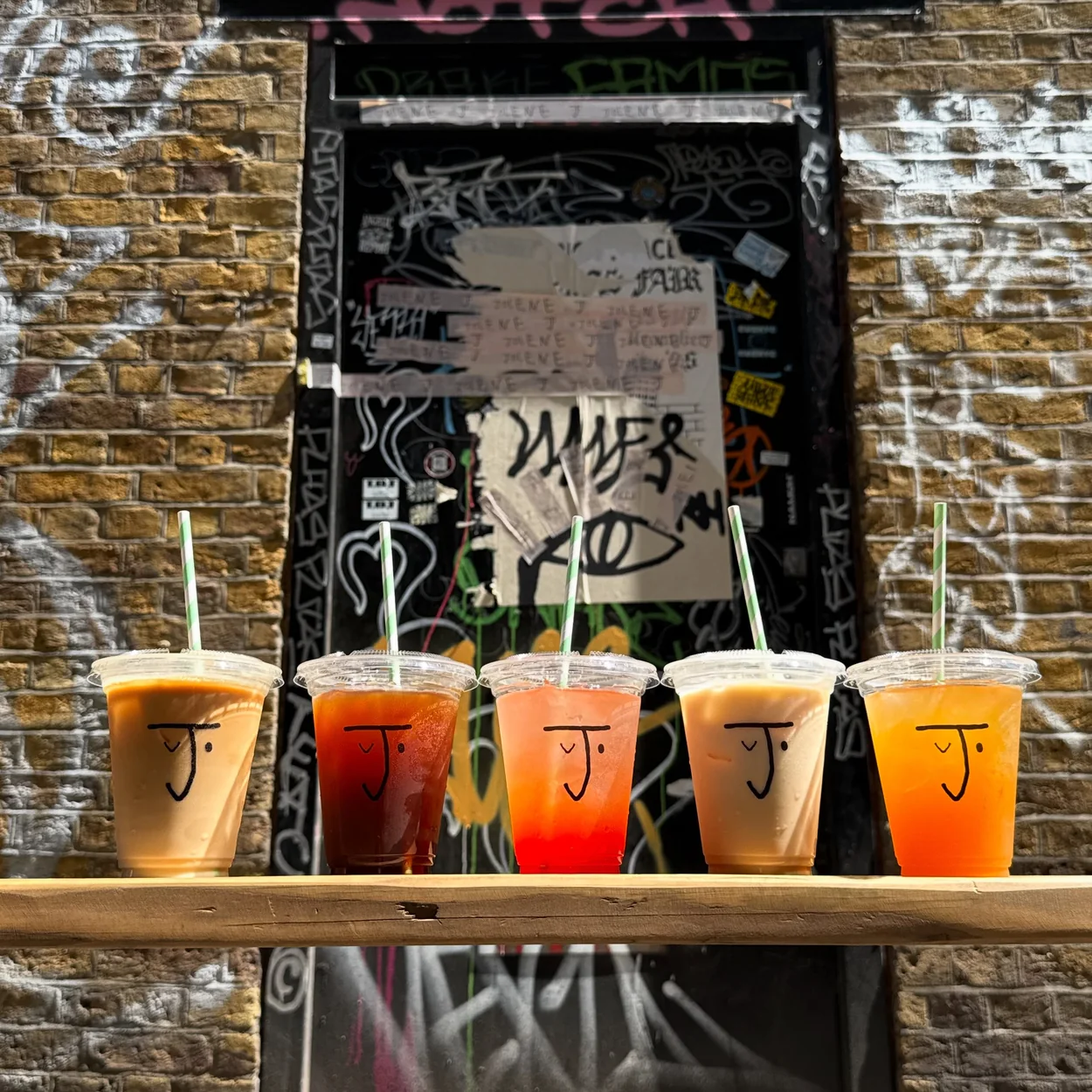 Iced coffees and juices lined on a bench outside Jolene on Bridle Lane