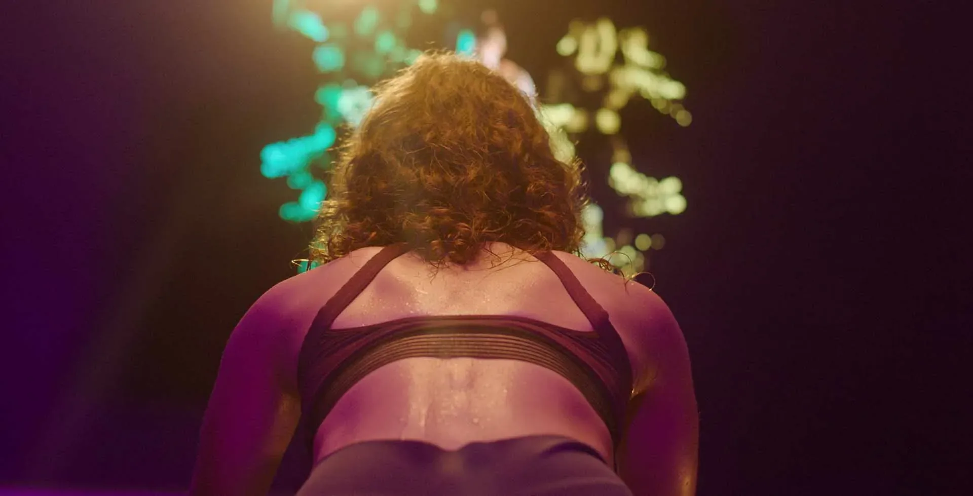 Stage-lit dance performance frame from a Lambda Films corporate film production