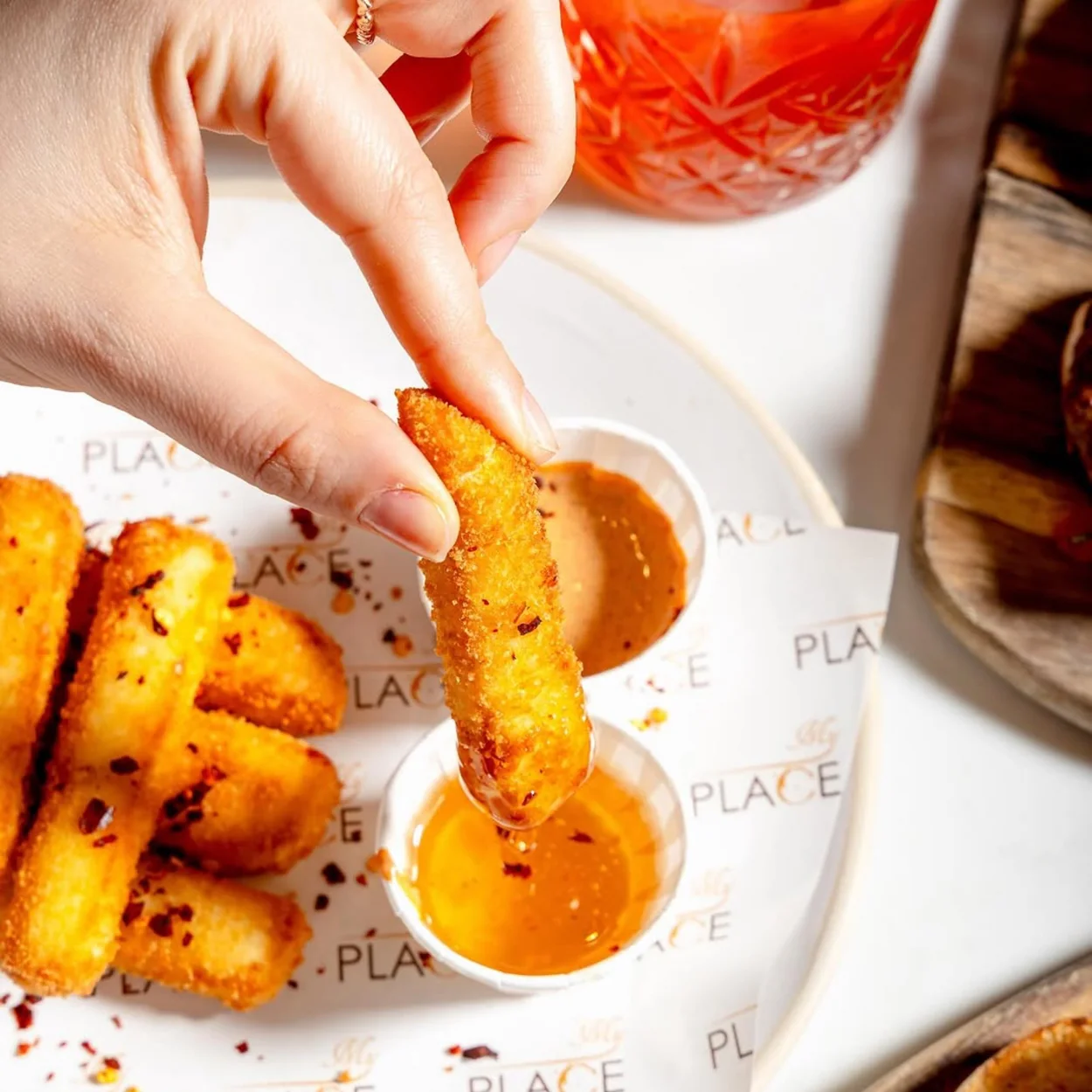 Halloumi fries dipped into spiced sauce at My Place, the Soho brunch spot