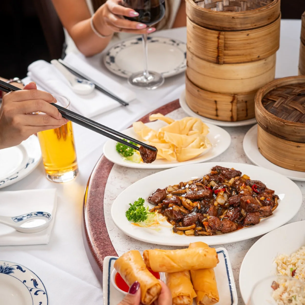 Table of roast duck, spring rolls and dim sum at New Young Cheng in Chinatown