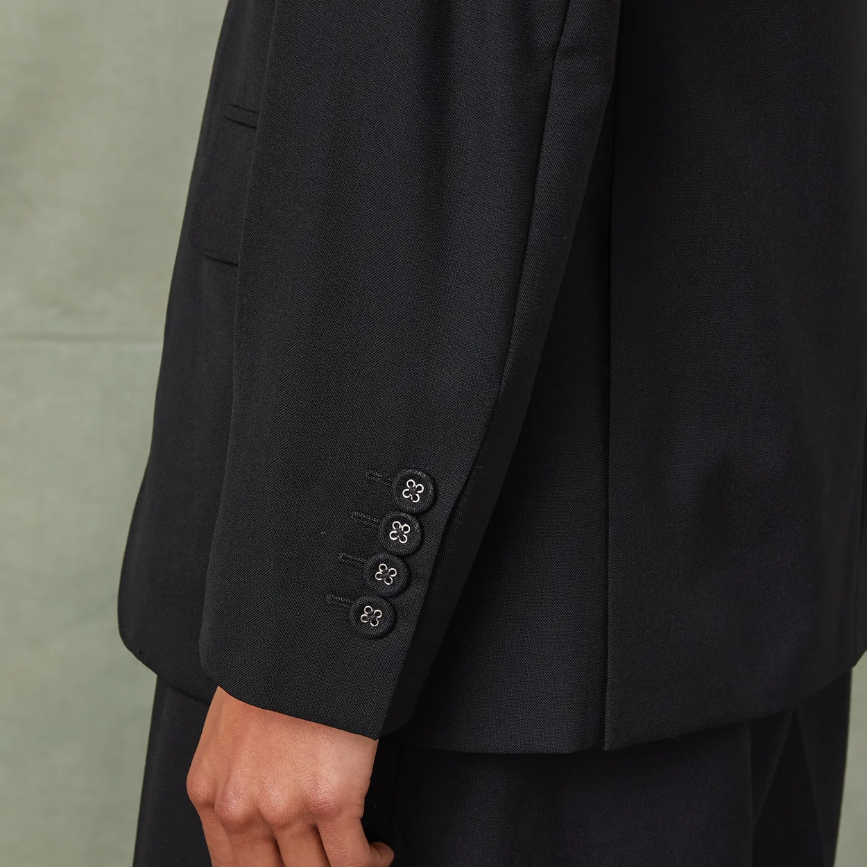 Sleeve detail of a navy Officine Generale blazer from the Paris label's Soho store