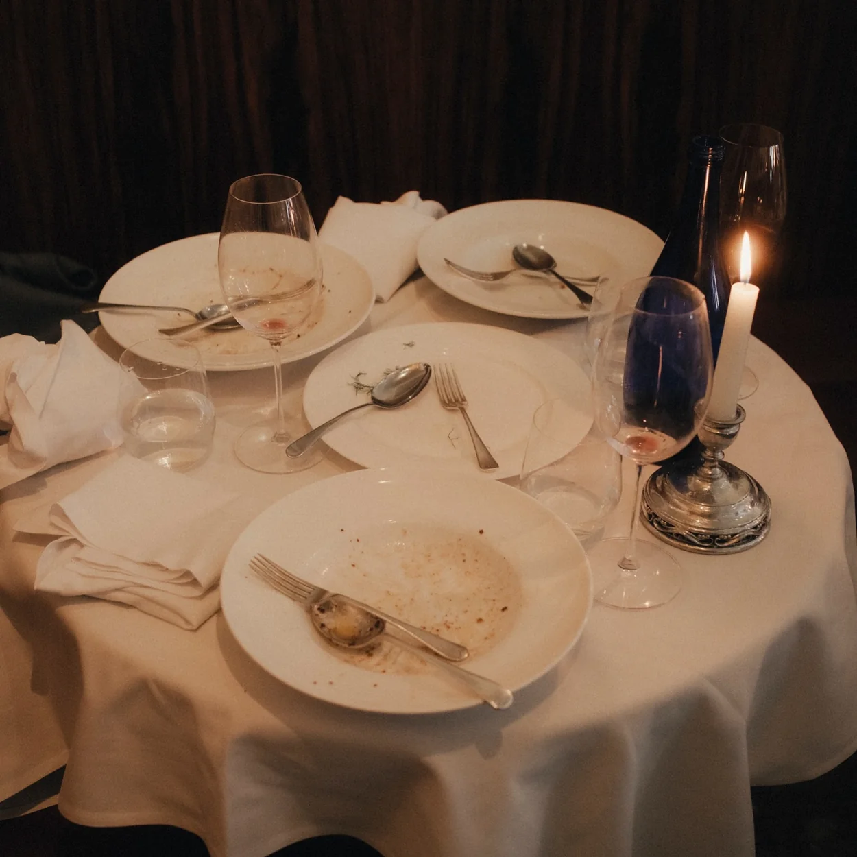 Candlelit table set with white linen at Osteria Vibrato, the Greek Street osteria