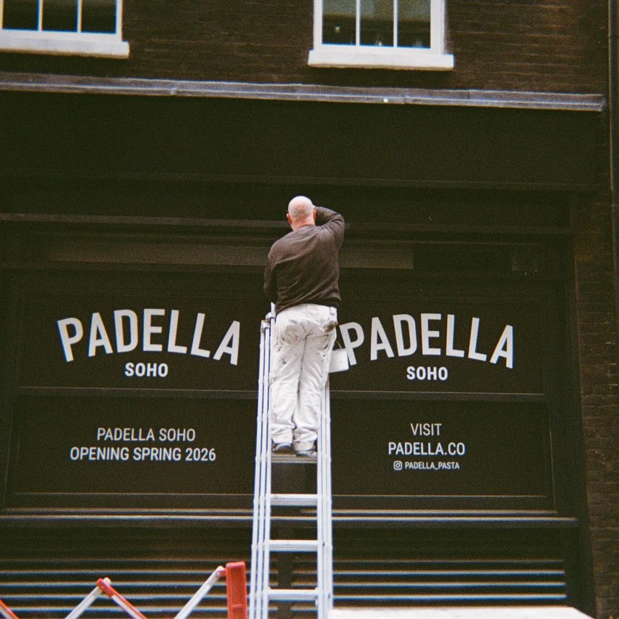 Signwriter painting the Padella Soho fascia ahead of the pasta restaurant's opening