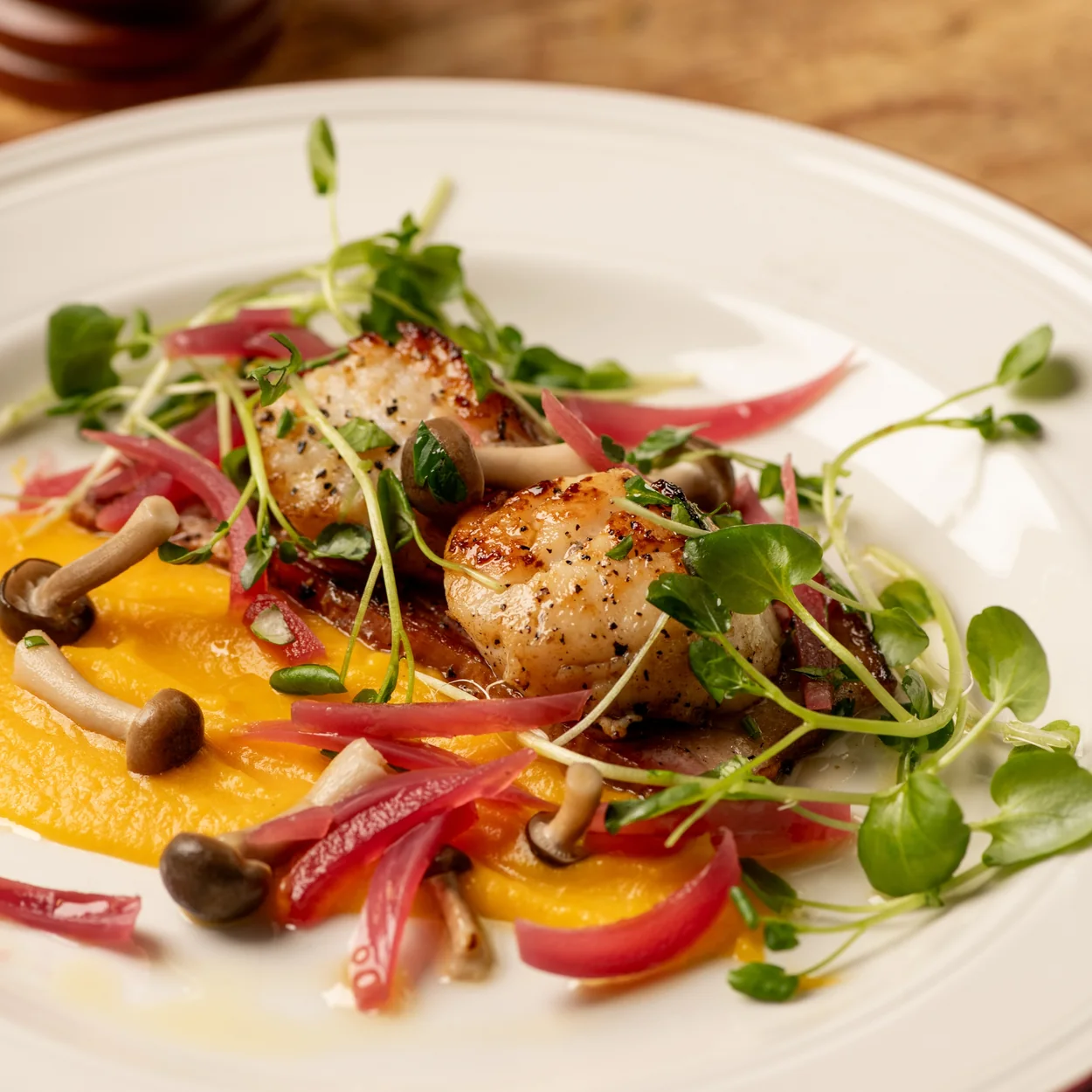 Seared scallops with mushrooms and pickled onion at Prix Fixe, the Soho bistro