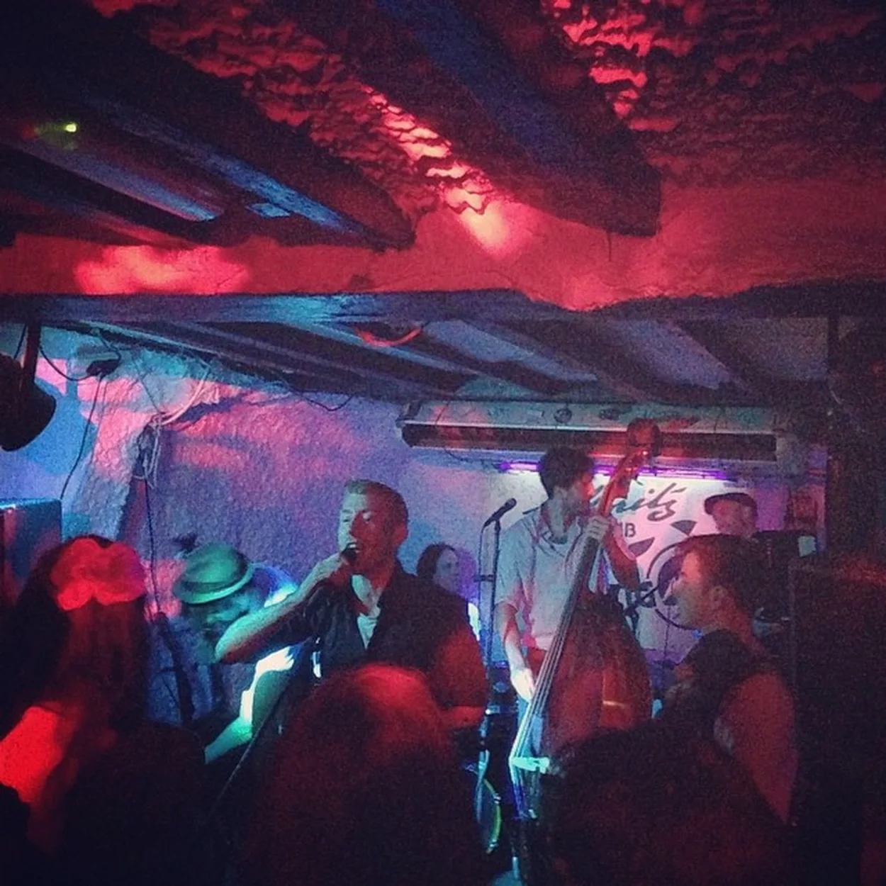 Live band lit red and blue in the cellar of the St Moritz Club on Wardour Street