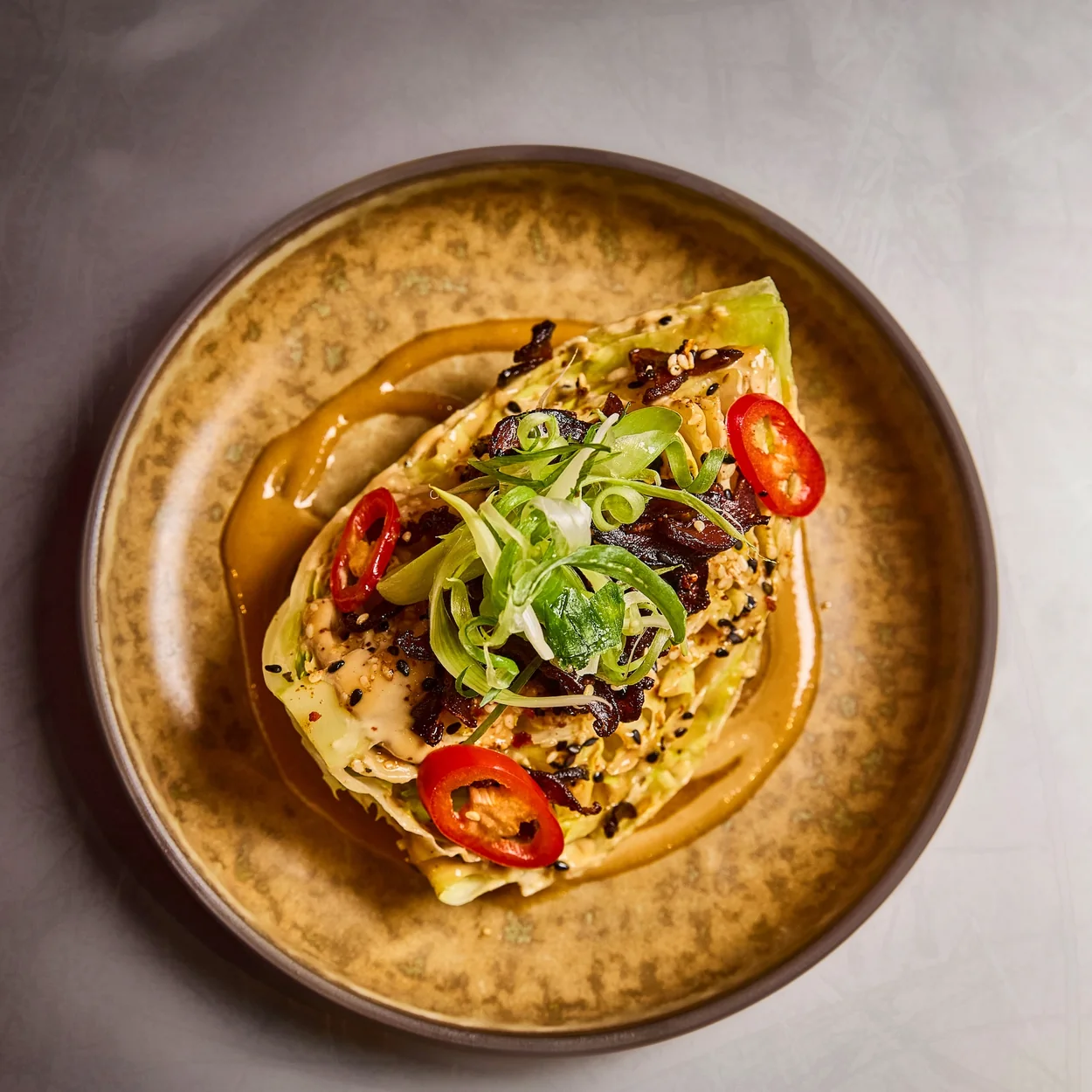 Chilli-topped small plate served on amber ceramics at Tangra, the Indo-Chinese restaurant in Soho