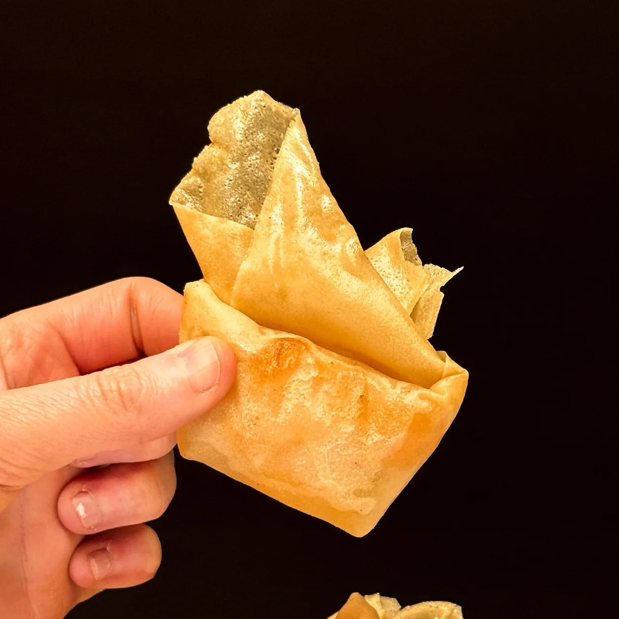 Crispy pastry parcel held up at Tao Tao Ju, the Cantonese restaurant in Chinatown