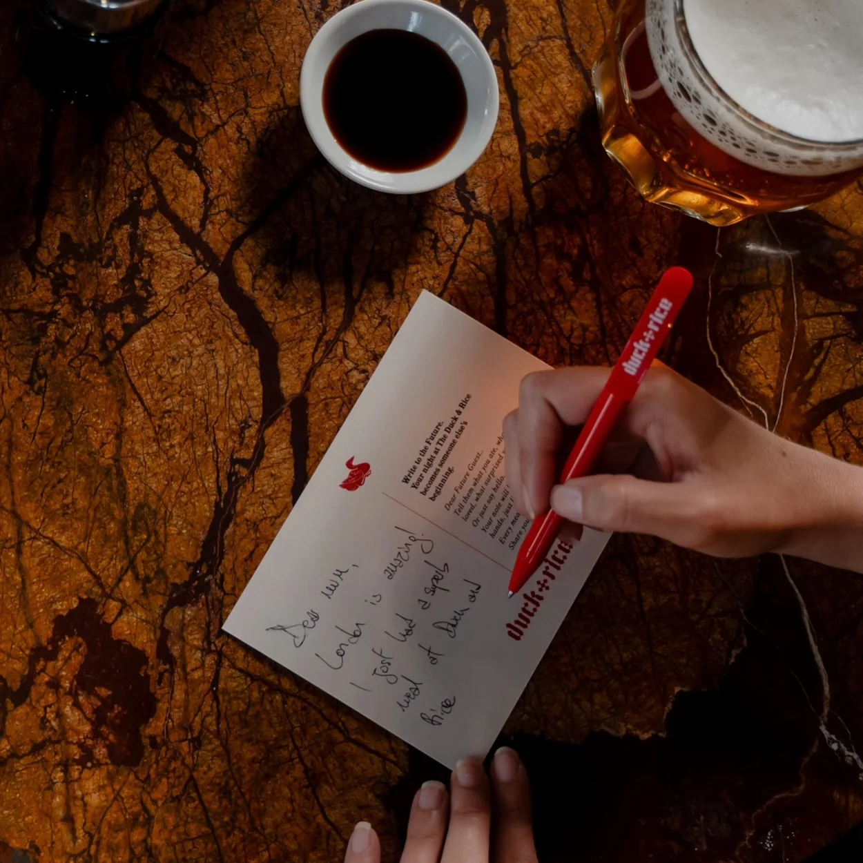 Marking the dim sum order card beside a glass of pilsner at The Duck and Rice