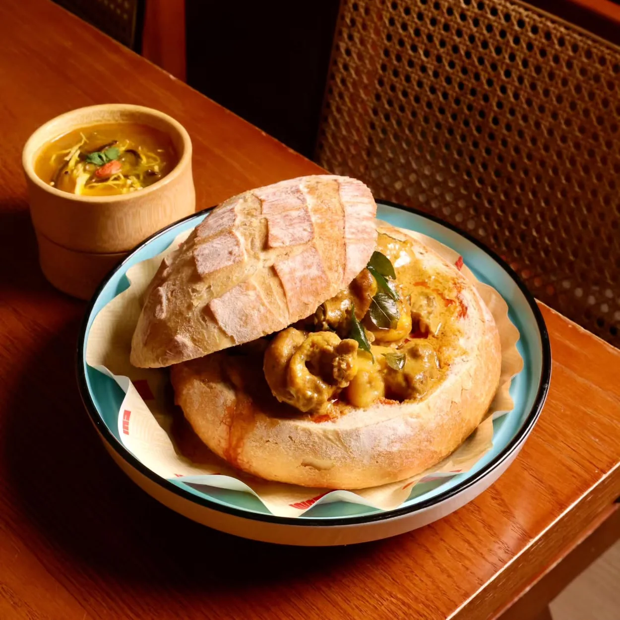 Curry served in a hollowed bread loaf at Yiqi, the pan-Asian restaurant in Chinatown