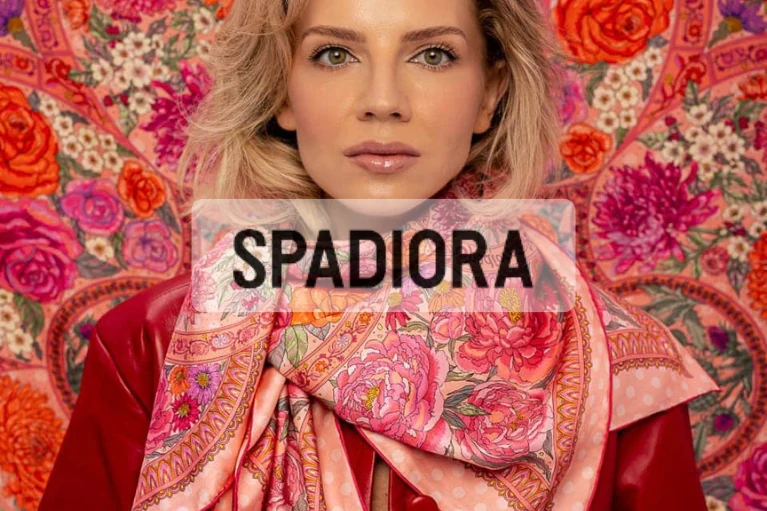 Woman wearing a pink floral silk twill scarf, a quiet luxury accessory